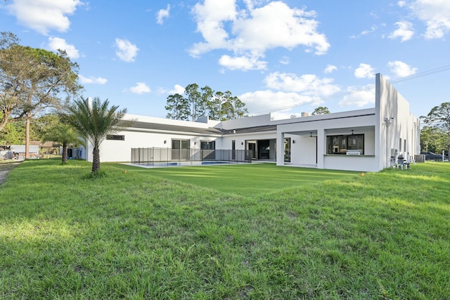 rear view of property featuring a lawn