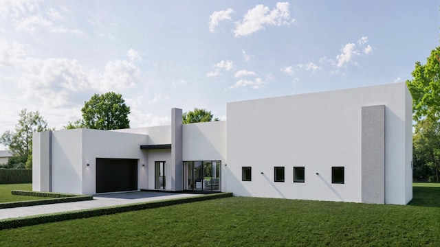 view of front of house featuring a garage and a front lawn