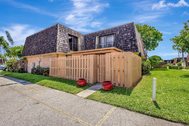 view of side of home with a lawn