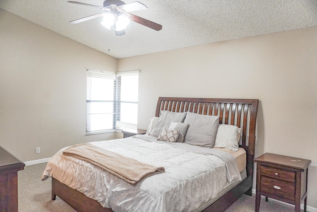 bedroom featuring a textured ceiling, ceiling fan, and carpet floors