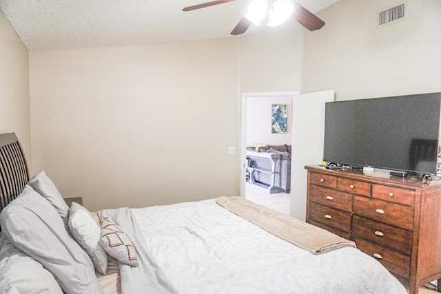 tiled bedroom featuring ceiling fan, high vaulted ceiling, and a textured ceiling