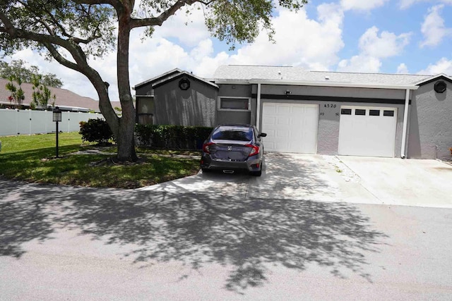 ranch-style home with a front lawn and a garage