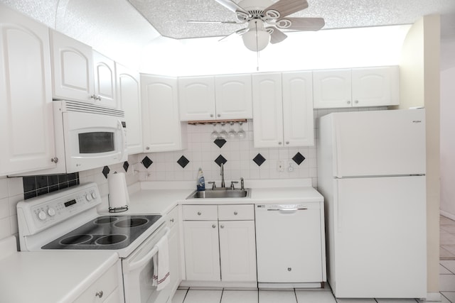 kitchen featuring ceiling fan, white cabinetry, light tile patterned floors, white appliances, and sink