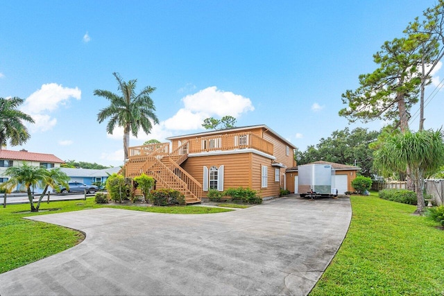 front of property with an outbuilding and a front yard