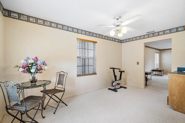 interior space featuring ceiling fan and a textured ceiling