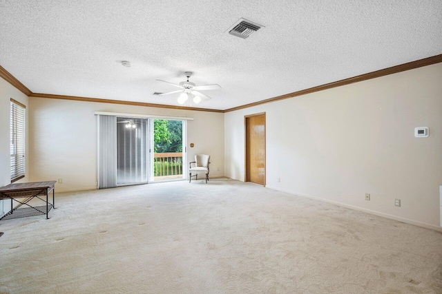 empty room with light carpet, ceiling fan, crown molding, and a textured ceiling