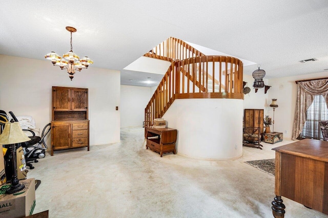 carpeted living room featuring a textured ceiling and a chandelier