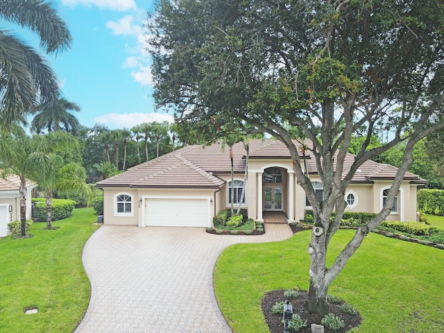 view of front facade with a front yard and a garage