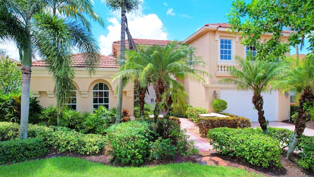 mediterranean / spanish-style home with a garage