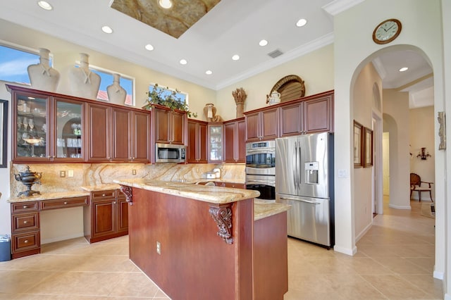 kitchen featuring decorative backsplash, appliances with stainless steel finishes, light stone counters, and light tile patterned floors