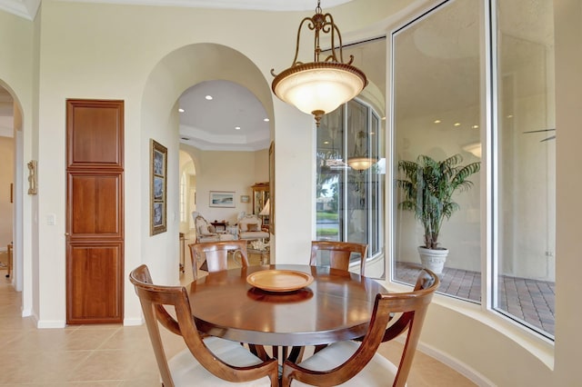 dining room featuring crown molding and light tile patterned floors