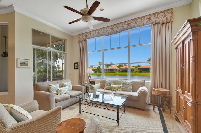 living room with ornamental molding, a water view, and ceiling fan