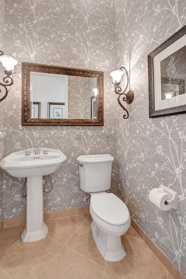 bathroom with tile patterned flooring and toilet