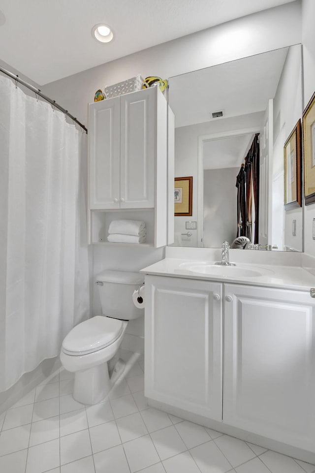 bathroom with tile patterned flooring, toilet, and vanity