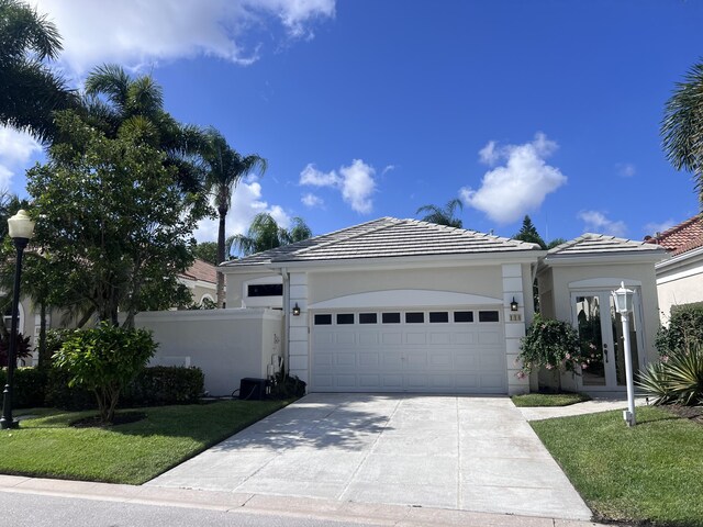 view of front of property featuring a garage and a front lawn