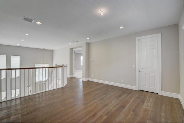 spare room with hardwood / wood-style floors