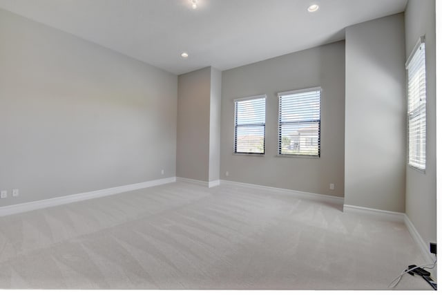 unfurnished room with light colored carpet