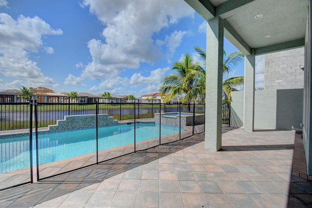 view of swimming pool featuring an in ground hot tub, a water view, and a patio