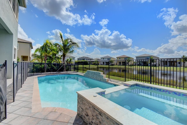 view of swimming pool featuring an in ground hot tub and a water view