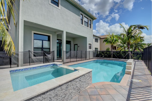 view of pool with a jacuzzi