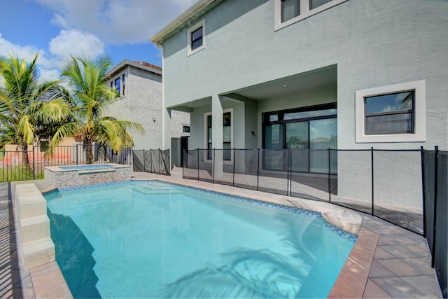 view of swimming pool featuring an in ground hot tub and a patio area