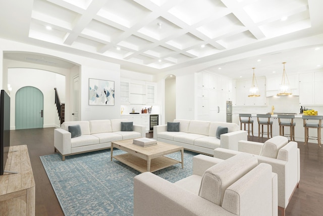 living room featuring dark hardwood / wood-style flooring, coffered ceiling, and beamed ceiling