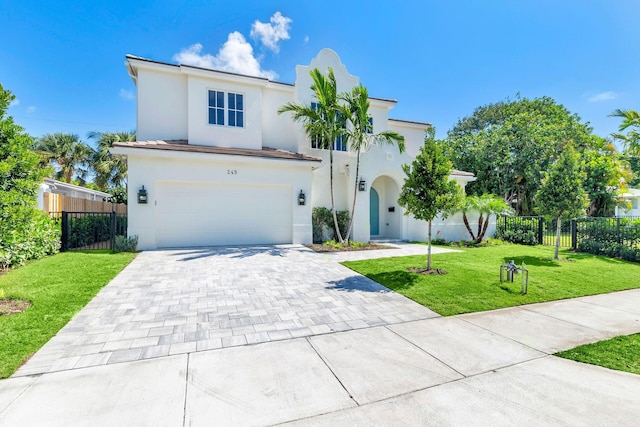 mediterranean / spanish-style home with a garage and a front lawn