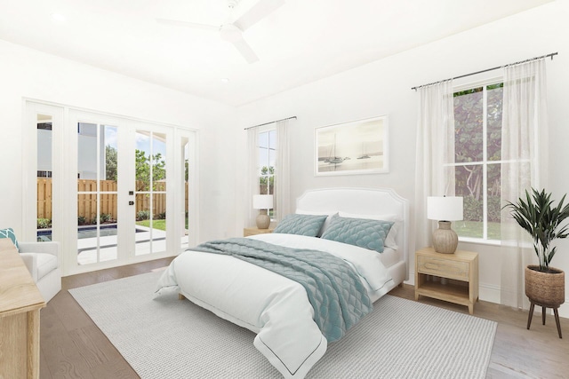 bedroom featuring ceiling fan, access to outside, light wood-type flooring, and french doors