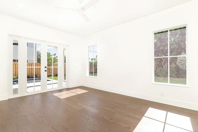 empty room with dark wood-type flooring, french doors, and ceiling fan