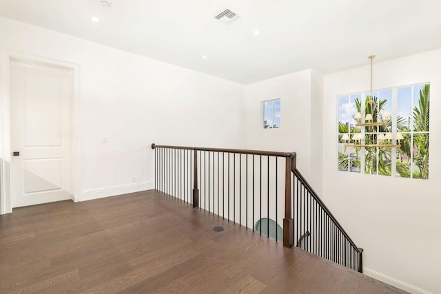 corridor featuring dark hardwood / wood-style floors