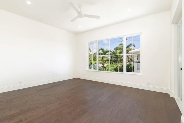 empty room featuring dark wood-type flooring and ceiling fan