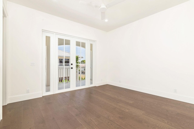 empty room featuring ceiling fan, dark hardwood / wood-style flooring, and french doors