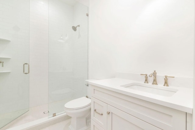 bathroom with vanity, a shower with shower door, and toilet