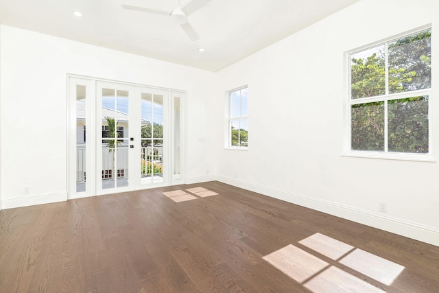 empty room with hardwood / wood-style floors and ceiling fan