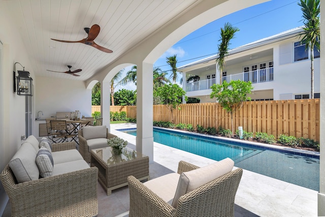 view of pool with a patio, sink, outdoor lounge area, and ceiling fan