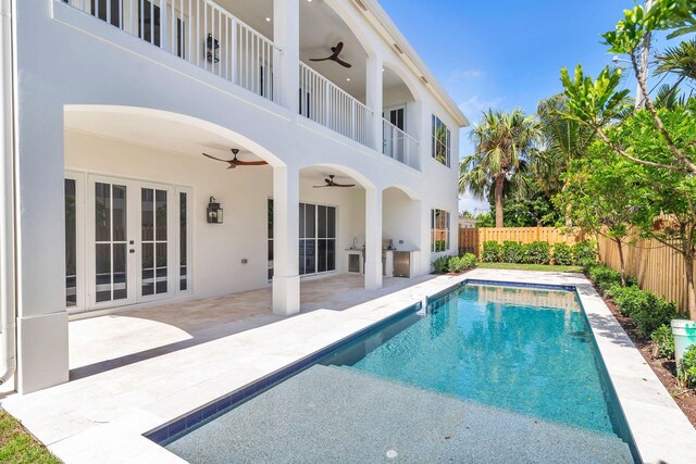 view of pool featuring a patio, ceiling fan, and french doors