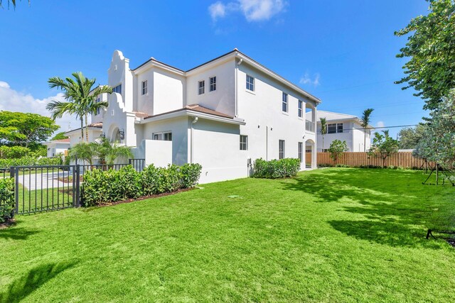 rear view of property with a lawn