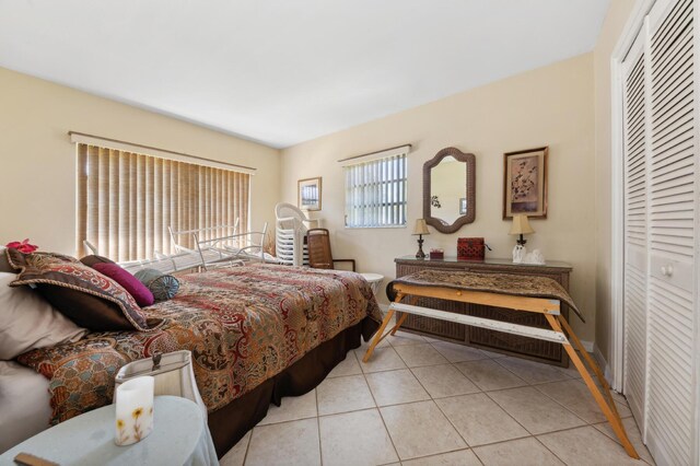 bedroom with a closet and light tile patterned floors