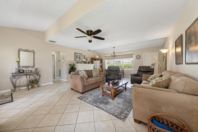 living room featuring ceiling fan with notable chandelier and light tile patterned floors