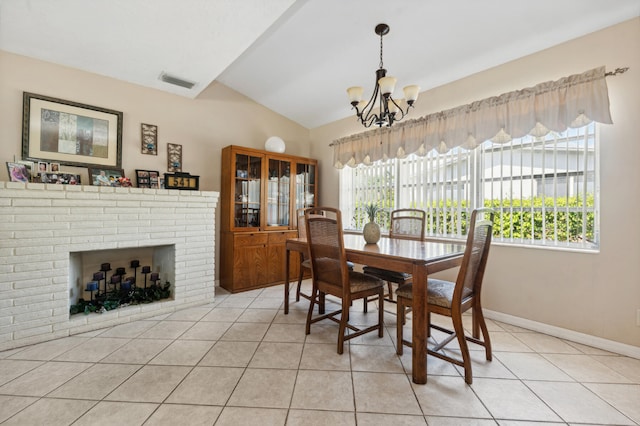 tiled dining area with a chandelier, lofted ceiling, a fireplace, and a wealth of natural light