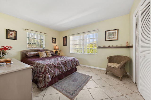 tiled bedroom featuring a closet