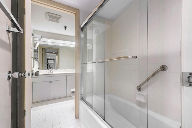 full bathroom with vanity, combined bath / shower with glass door, tile patterned flooring, and toilet