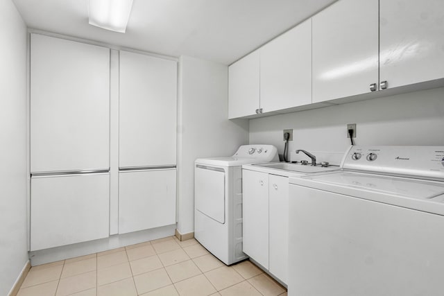 laundry area featuring sink, separate washer and dryer, cabinets, and light tile patterned floors