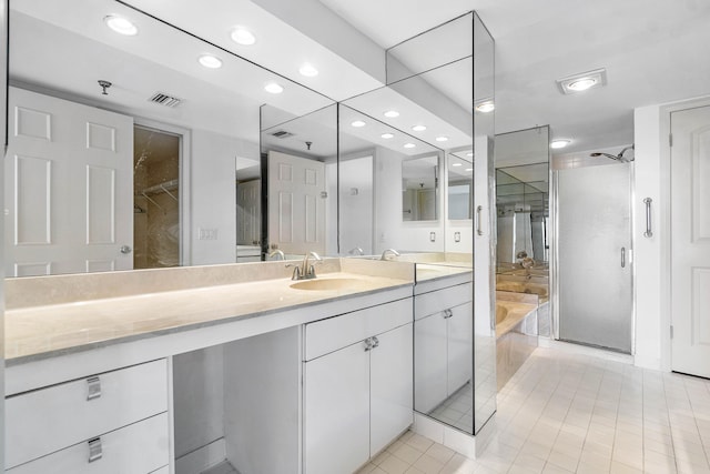 bathroom featuring vanity, tile patterned flooring, and an enclosed shower