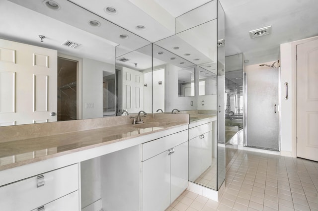 bathroom featuring vanity, tile patterned flooring, and an enclosed shower