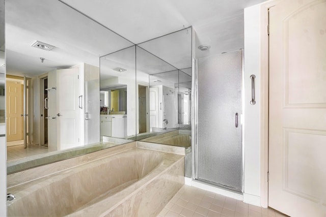 bathroom featuring vanity, tile patterned flooring, and separate shower and tub