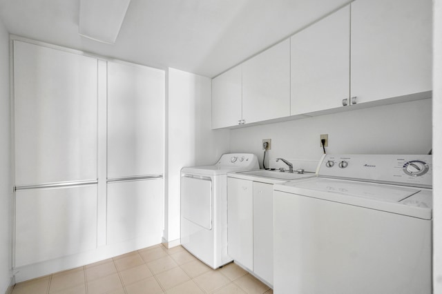 washroom with cabinets, washer and dryer, and light tile patterned flooring