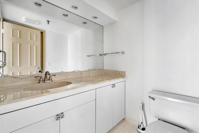 bathroom with tile patterned floors, toilet, and vanity