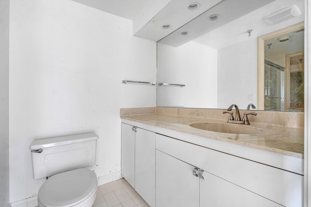 bathroom featuring vanity, tile patterned flooring, and toilet