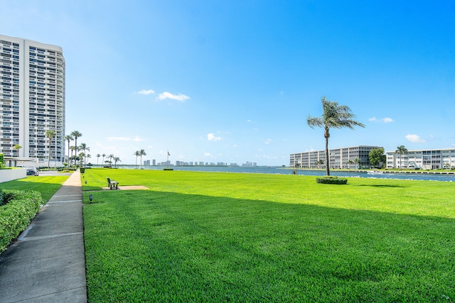 exterior space with a water view and a lawn